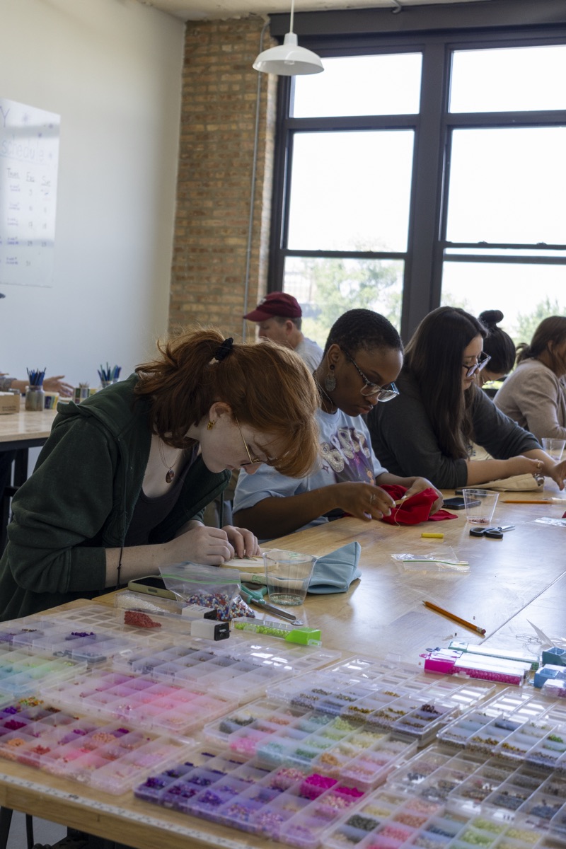 New friends crafting together at a long table